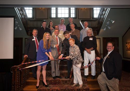 Contributors to the IAE exhibit assisted President Ransdell, Dan Murph and others in cutting the ribbon to officially open in the exhibit to the public.