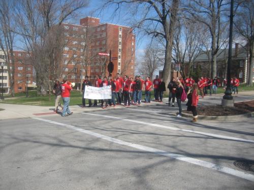 Approaching the end of the mile, WKU male students break in their red pumps in support of Walk-A-Mile In Her Shoes 2013