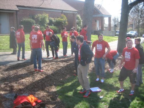 Lots of red high heeled WKU men preparing to Walk-A-Mile In Her Shoes