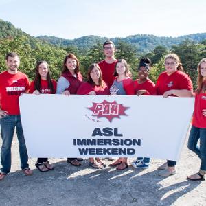 View PAH Executive Staff holding the PAH ASL Immersion Weekend banner Larger