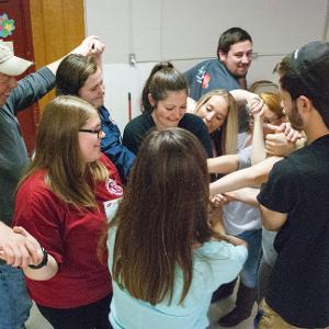View Group of participants playing the knot game as an ice-breaker activity Larger