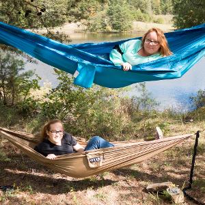 View Two participants outside in hammocks, bunkbed style, during free time Larger