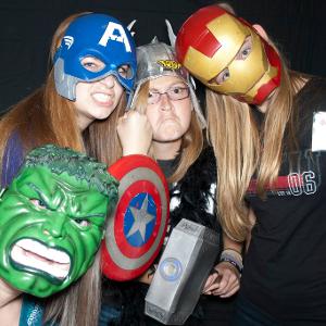 View Participants wearing Marvel hero masks, in a photo booth style picture Larger