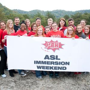 View Executive Staff holding the PAH ASL Immersion Weekend sign Larger