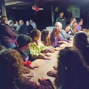 View Participants sitting around a long table playing the "beaver" game Larger