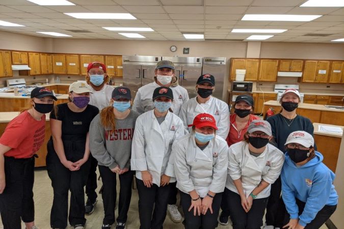 Group of students posing in the HMD kitchen.