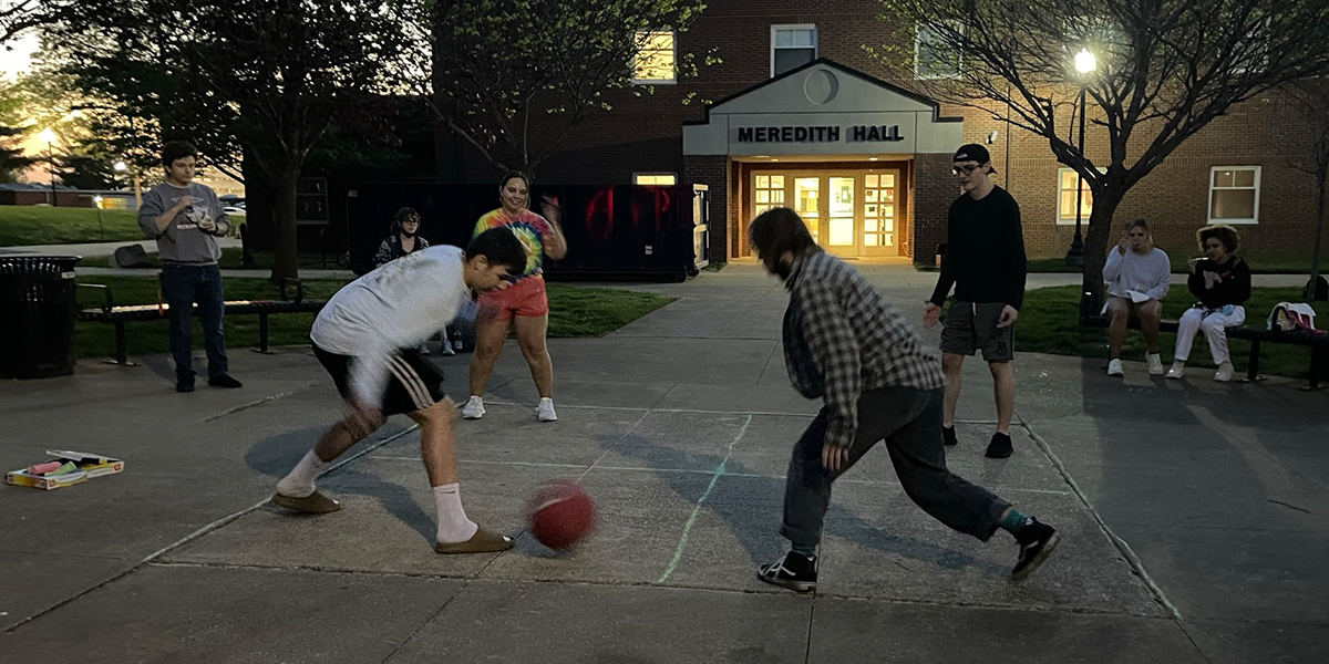 Students play foursquare outside Meredith Hall
