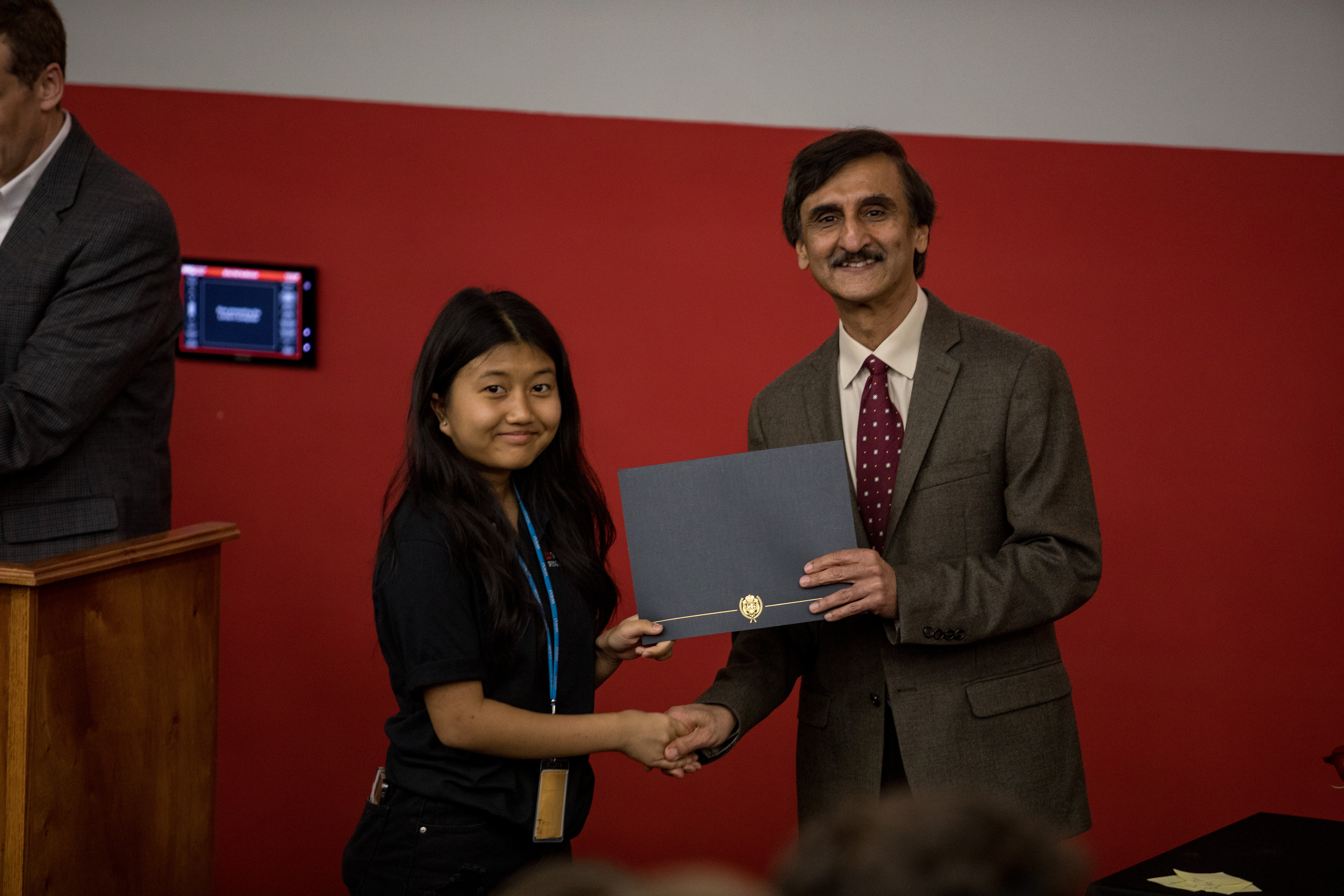 WKU Finance department head Dr. Chhachhi hands out award to a student at the camp award ceremony.