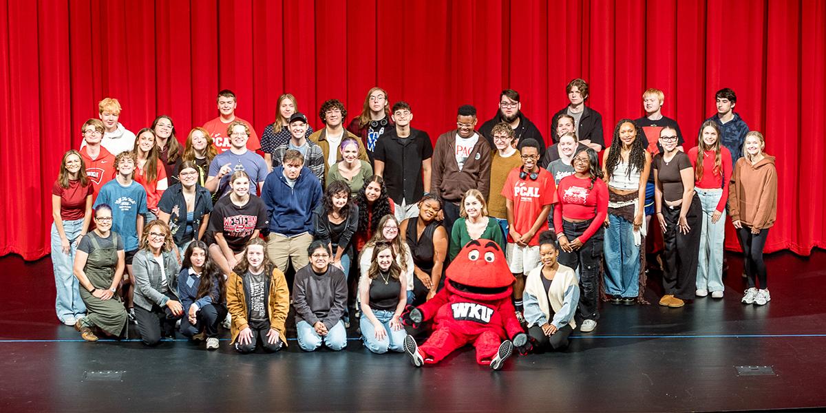 Creative Arts LLC on stage with Big Red