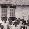 View Warren County's first Rosenwald School opened July 16, 1923 in the Cox Springs District. The two-teacher facility, located outside the western edge of Bowling Green, had two classrooms measuring 22' x 30', each with its own entrance and vestibule, two cloakrooms and a 12' x 12' community room. Reverand Henry D. Carpenter stands with students posed in front of the schoolhouse. (Courtesy of Library Special Collections, WKU) Larger