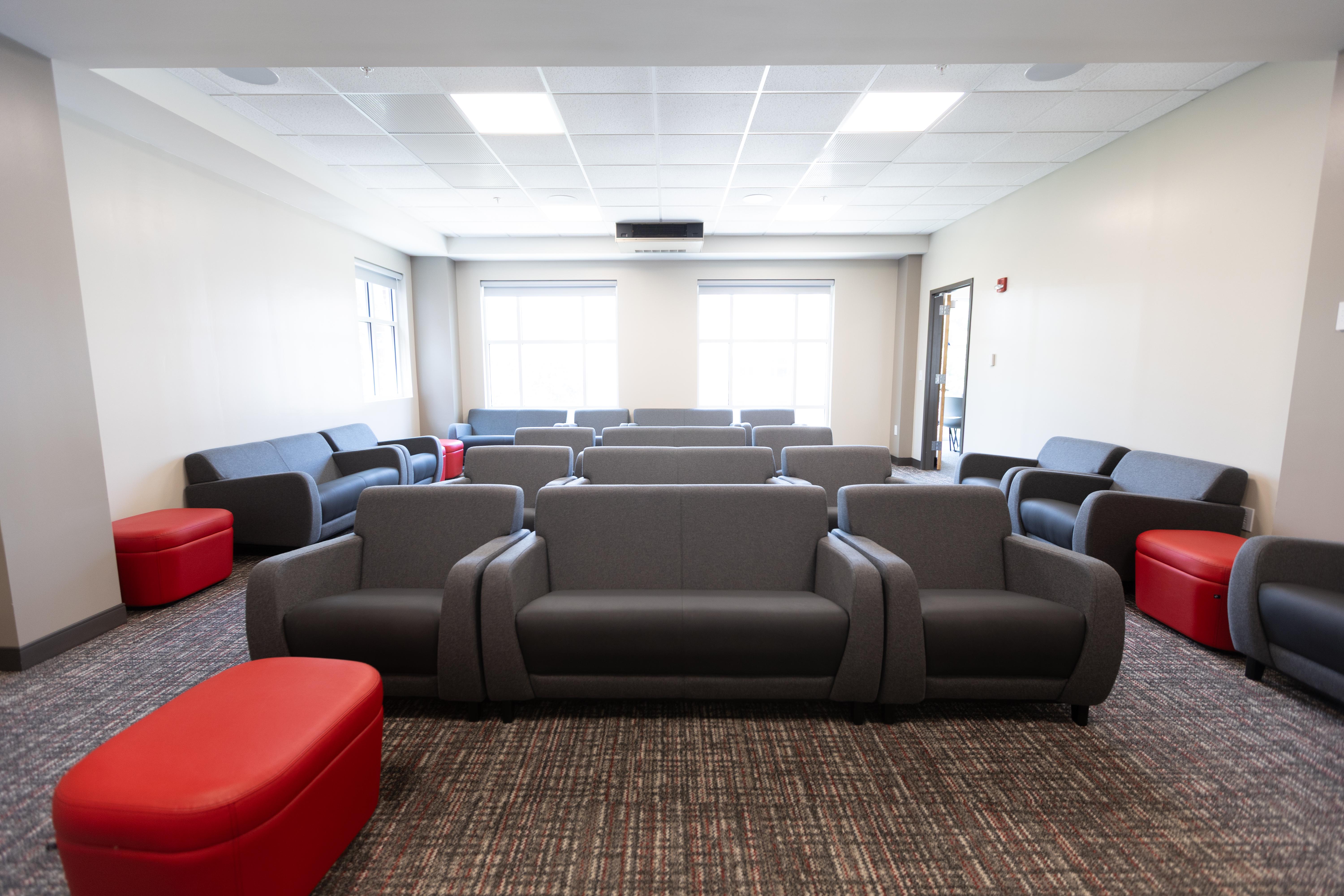 Photo of renovations to the third floor of Southwest Hall, showing a lounge and theatre room space