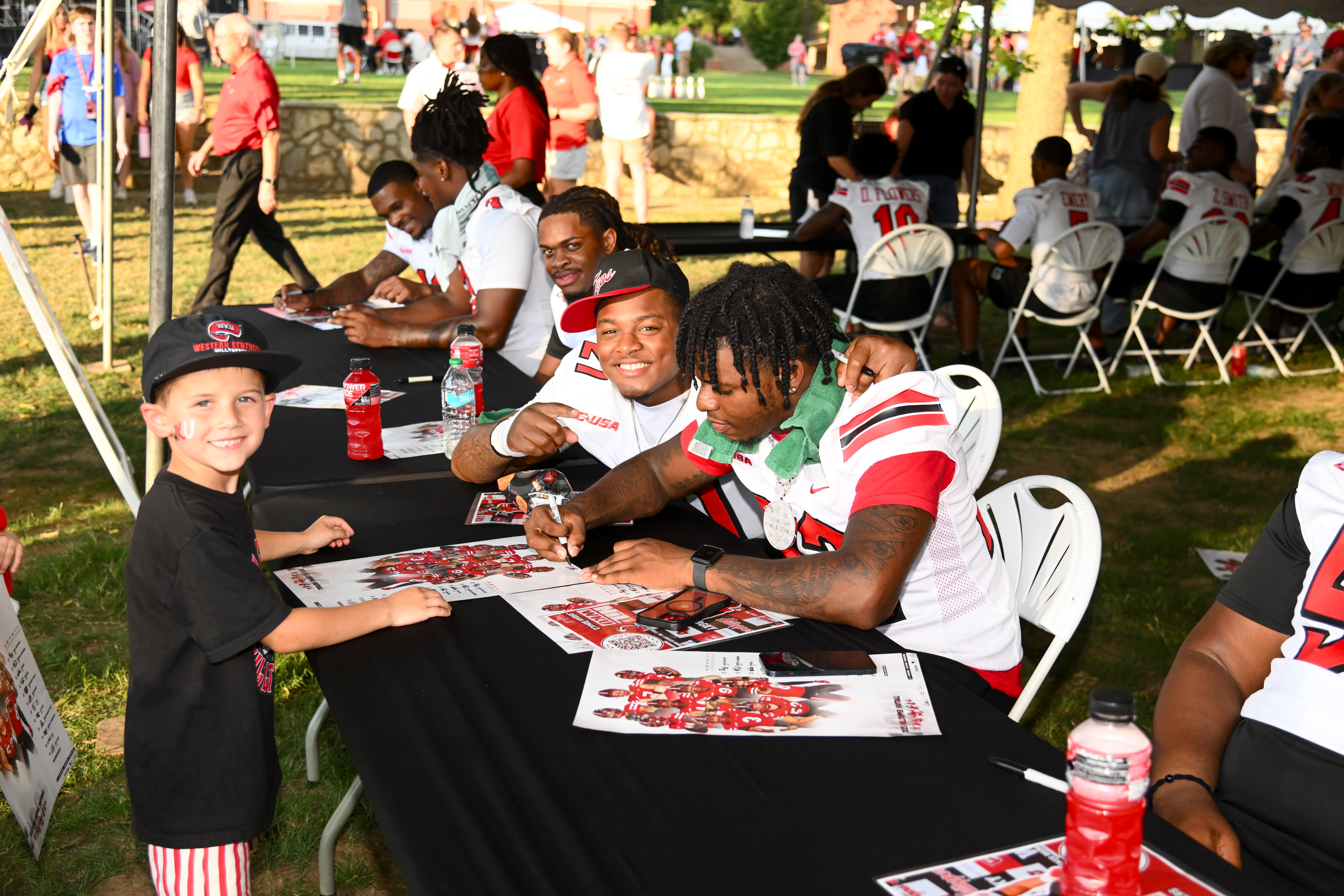 WKU student-athletes signing autographs at Topper Fest