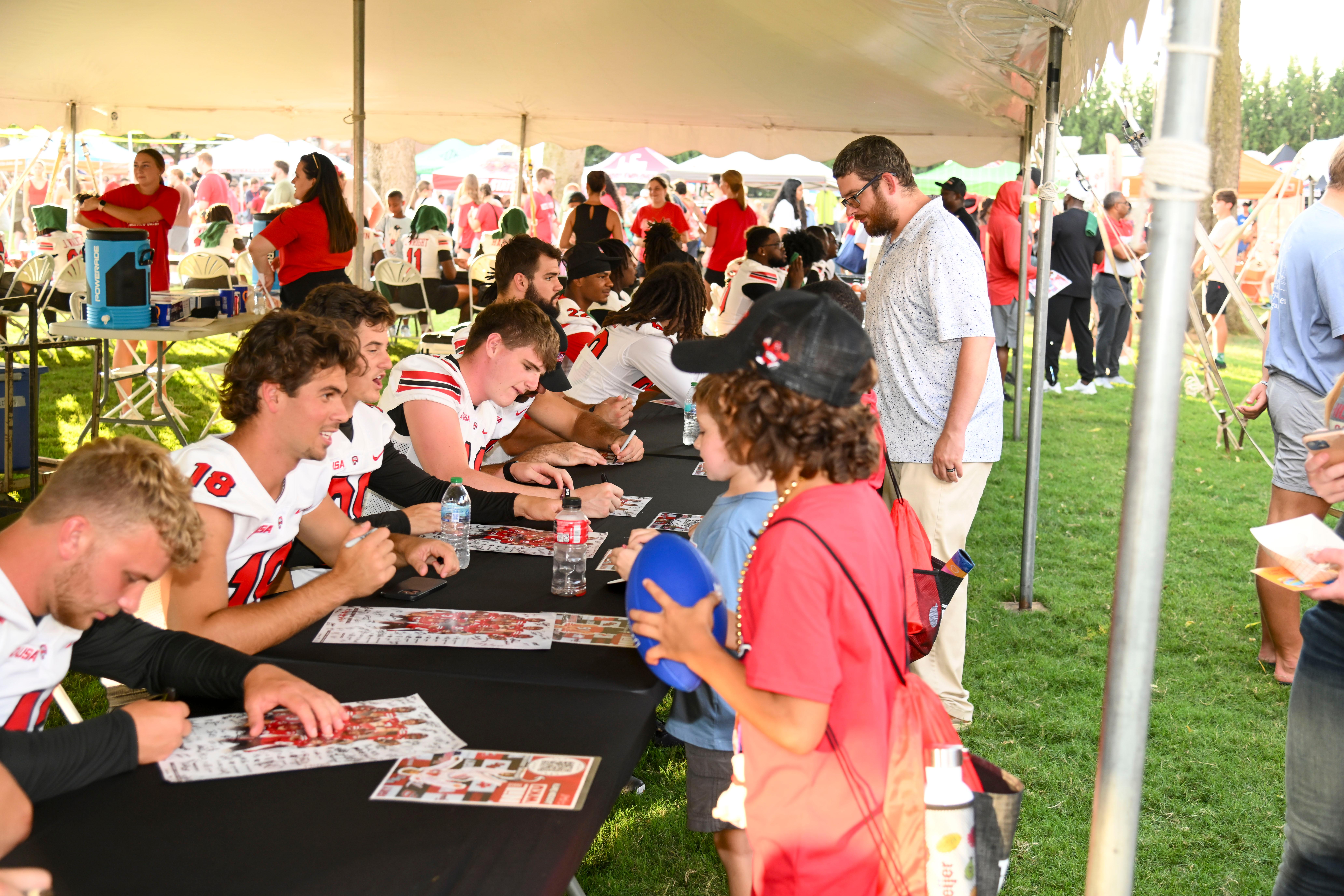 WKU student-athletes signing autographs at Topper Fest