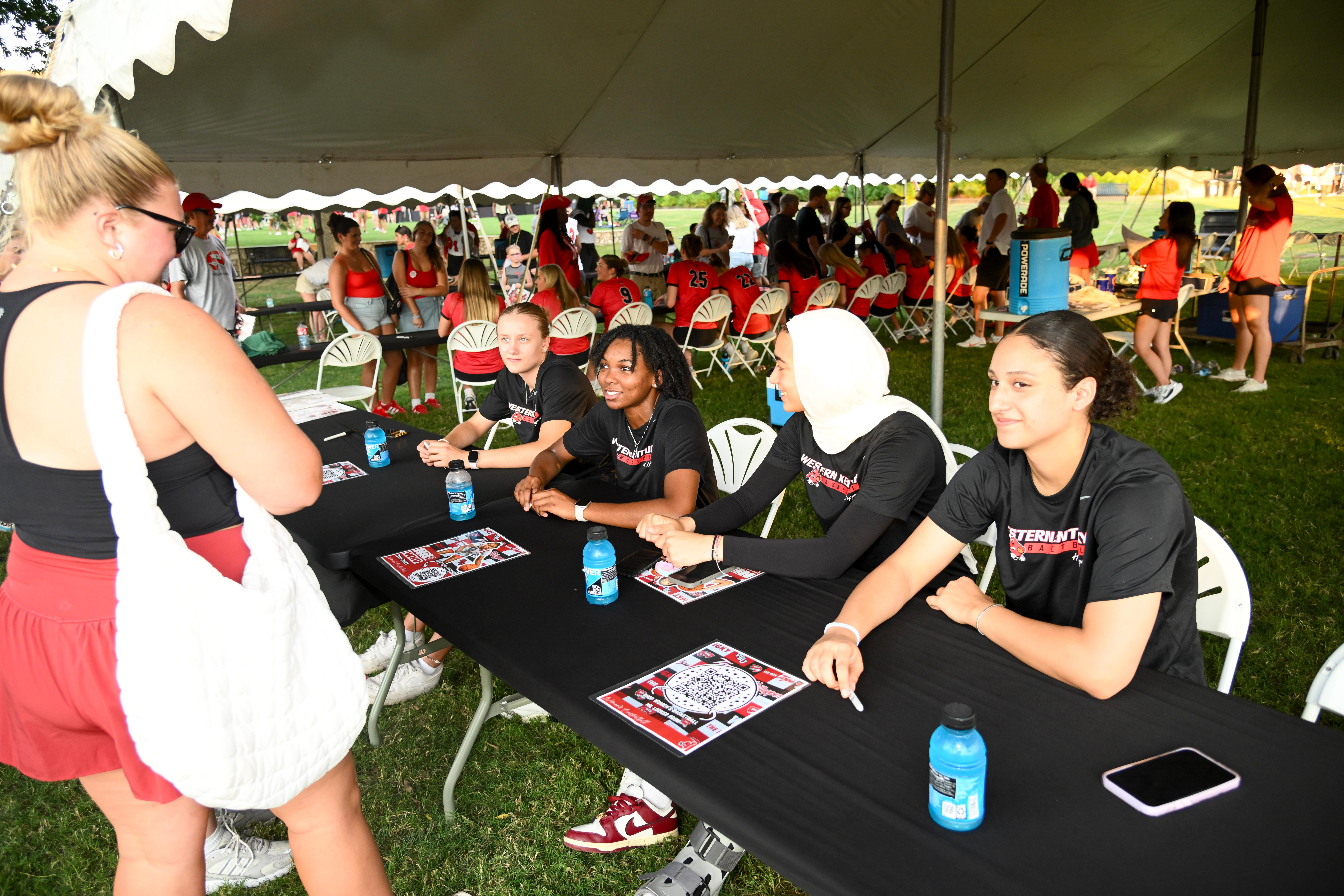 WKU student-athletes signing autographs at Topper Fest