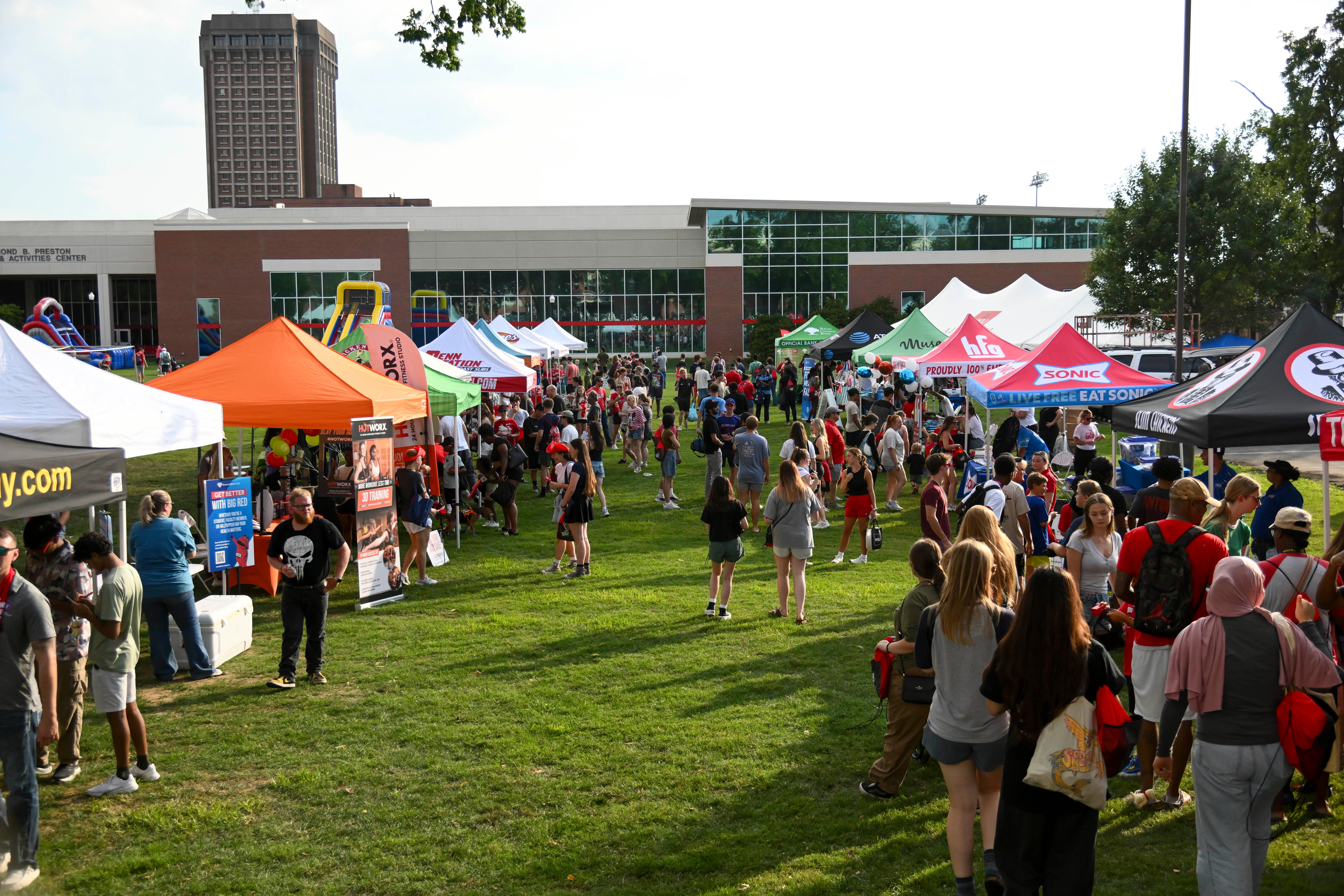 Large crowd of people visiting tents on WKU South Lawn during Topper Fest