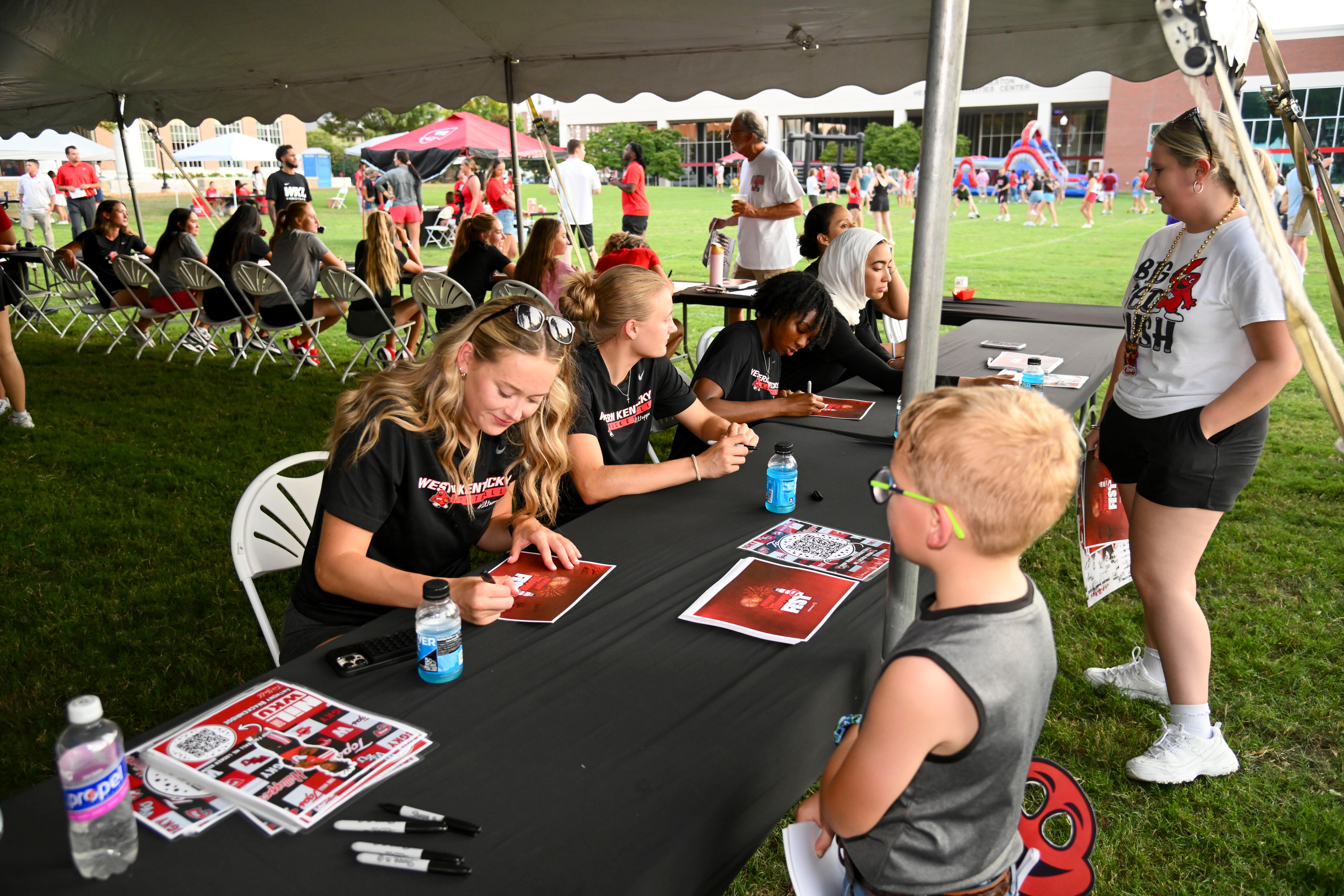 WKU student-athletes signing autographs at Topper Fest