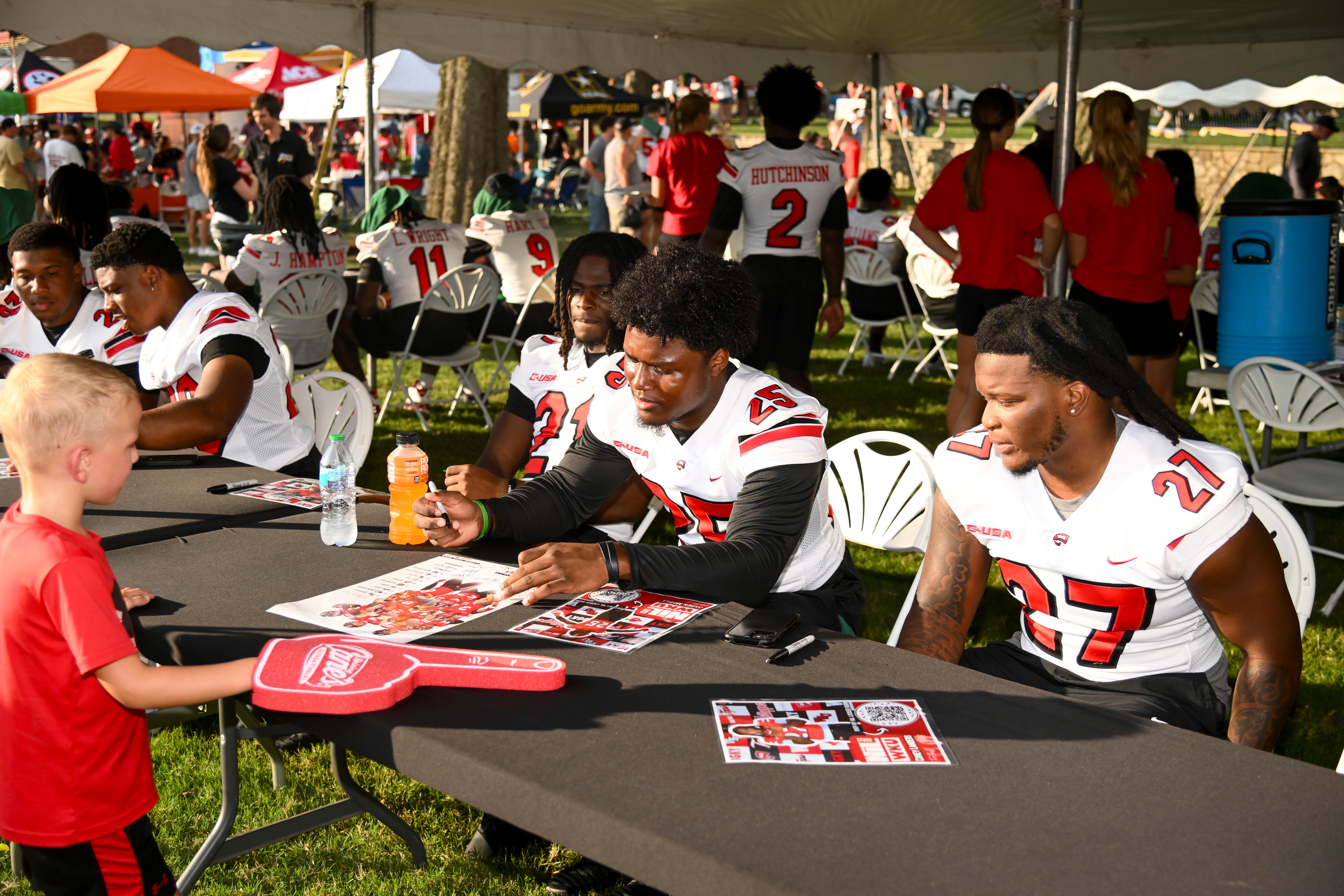 WKU student-athletes signing autographs at Topper Fest