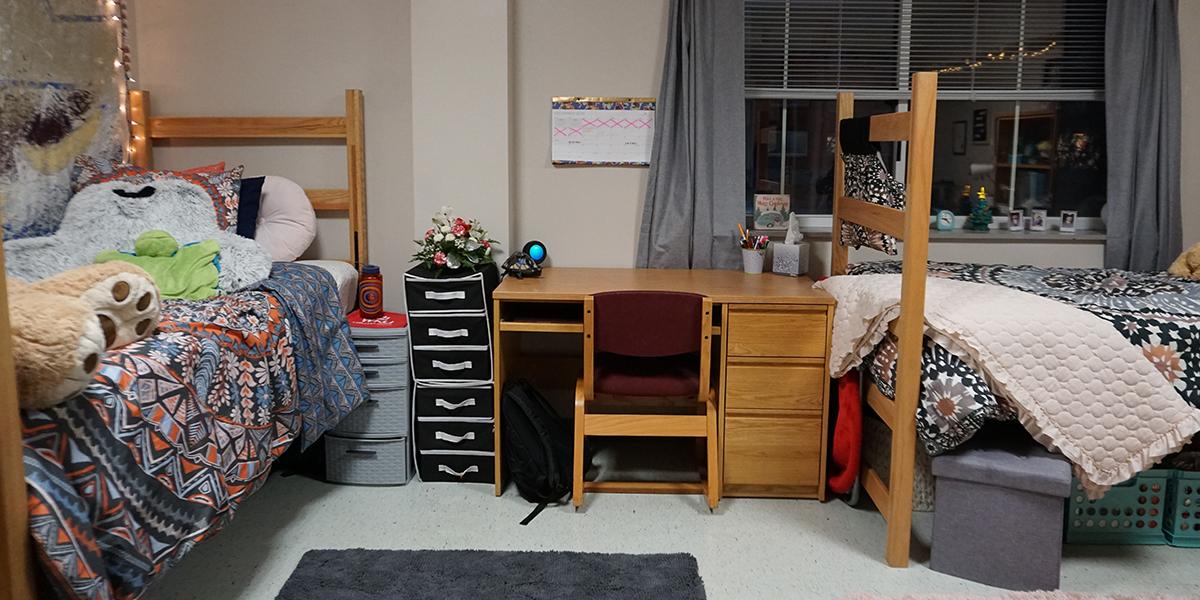 two beds and a desk in southwest hall