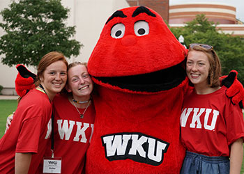 Three student pose with Big Red