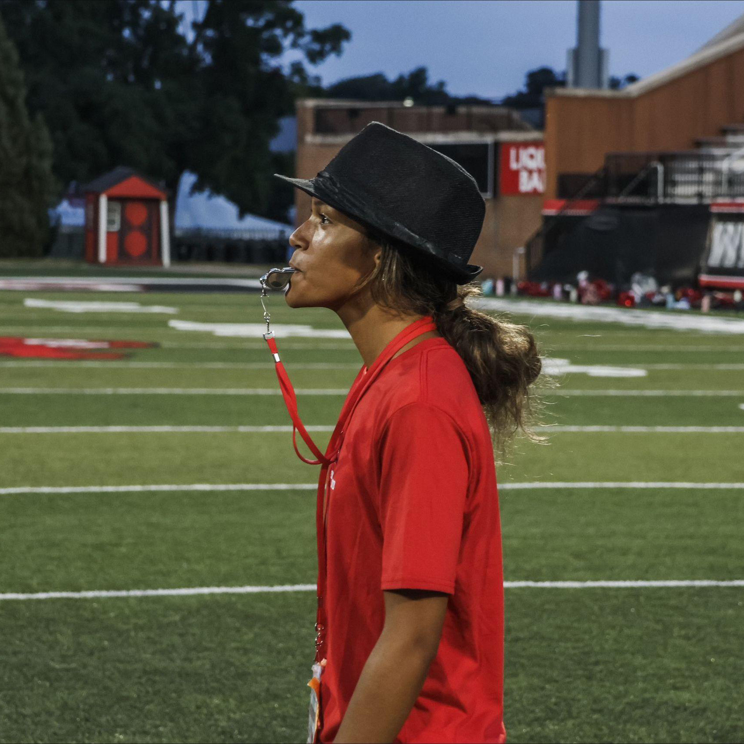 Aaliyah Henry standing on the football field with a whistle