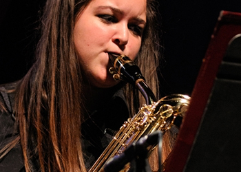Woman playing a woodwind instrument.