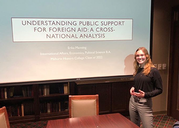 Woman presenting at a conference.