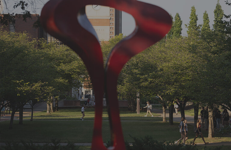 A red abstract steel sculpture in the center of WKU's main campus