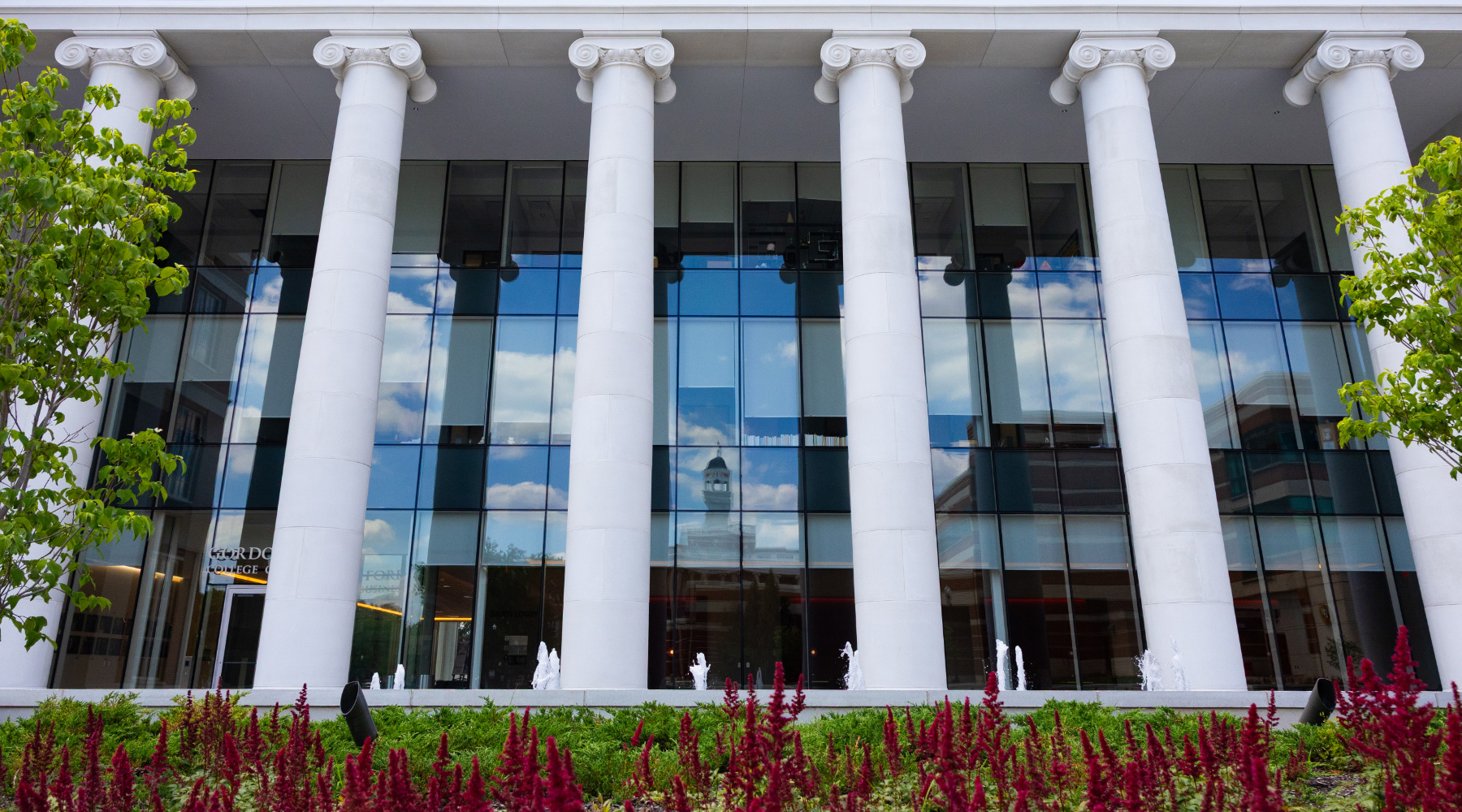 David & Amy Chandler Hall, a building with white columns and dark red flowers on WKU's main campus