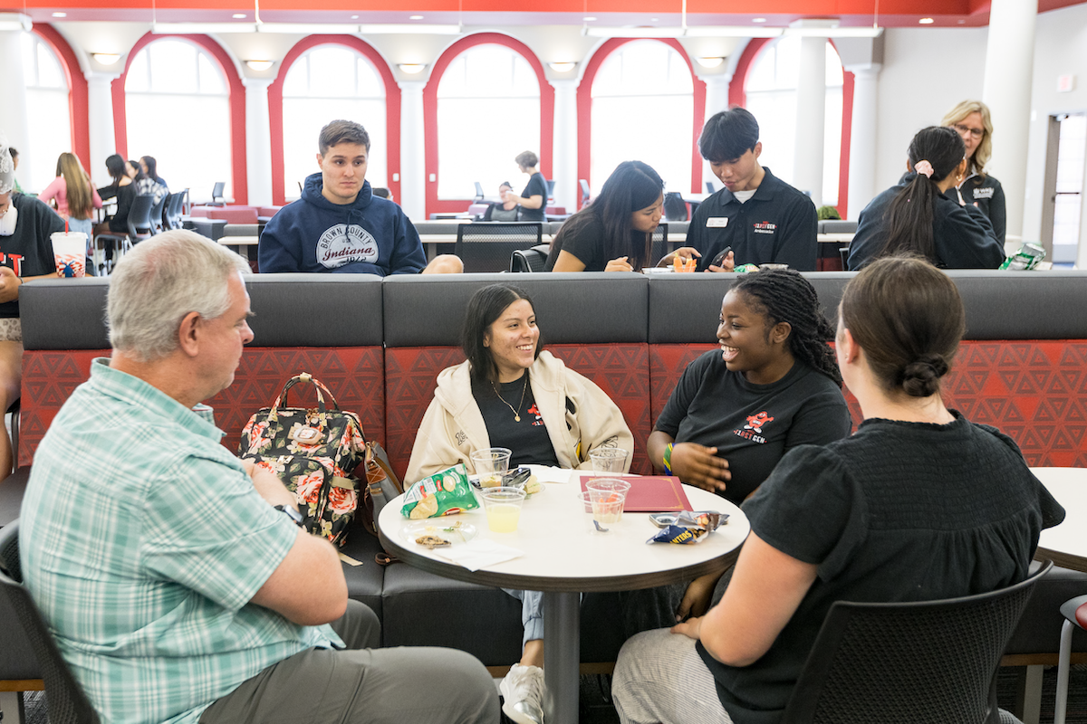 A group of F1rstGen students talk at the First Generation Day Celebration.