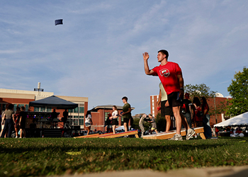 Student throwing a beanbag at Topper Fest