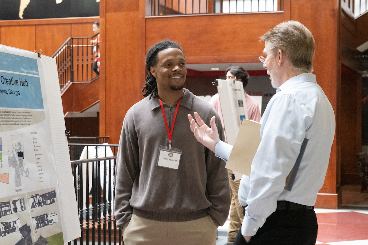 A WKU student presents his research at the Student Scholar Showcase.