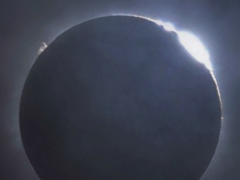 An image of the sun fully eclipsed.